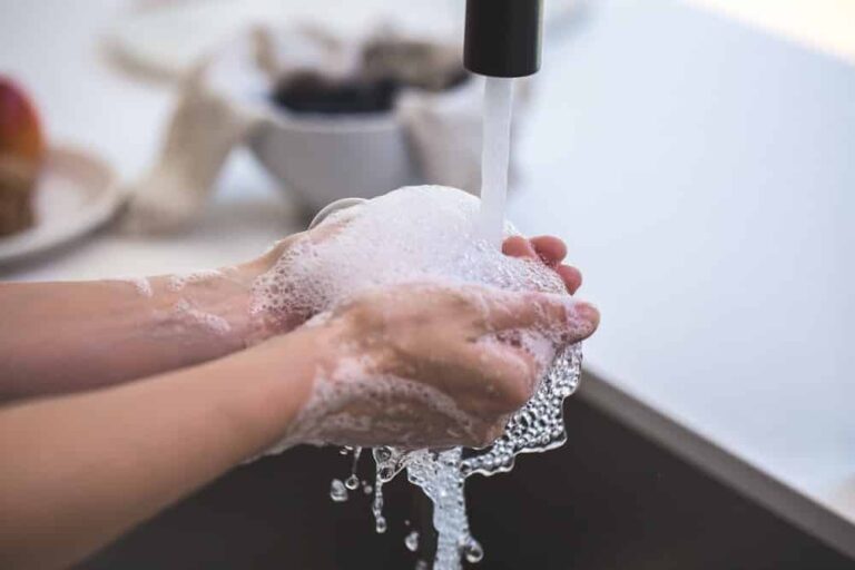 Woman washing hands in sink