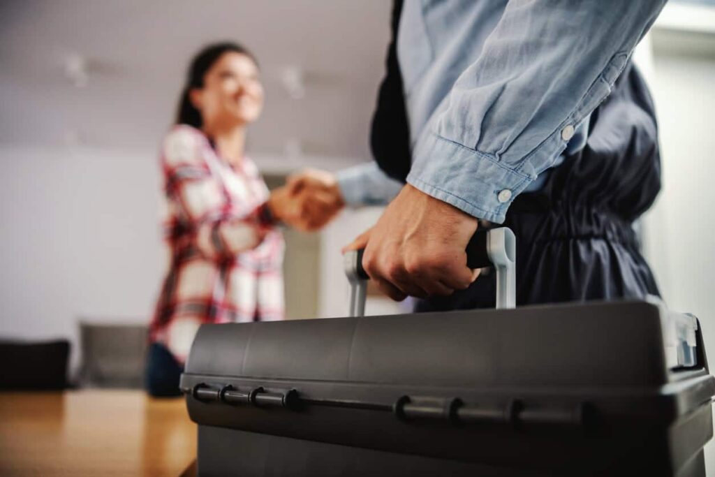 A water softner technician speaking to a homeowner