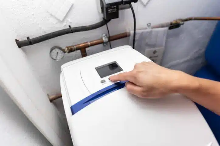 A technician setting up a water softener system