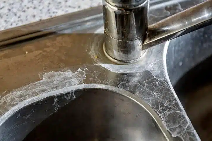Hard Water Stains On A Kitchen Sink and Faucet