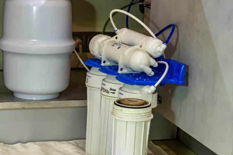 A water filter set up beneath a sink.